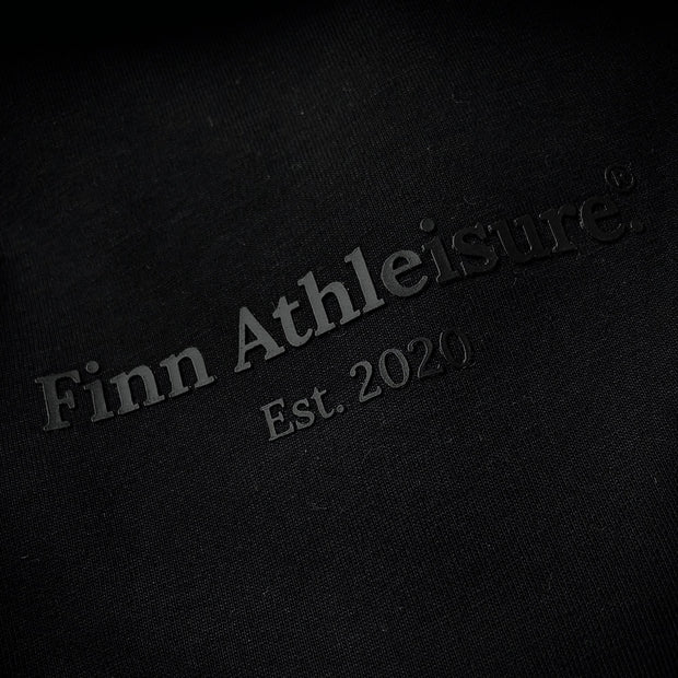 Black trademark Finn Athleisure print on black fabric