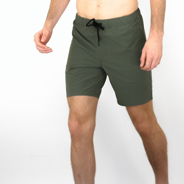 Front view of model wearing Squad Green shorts 