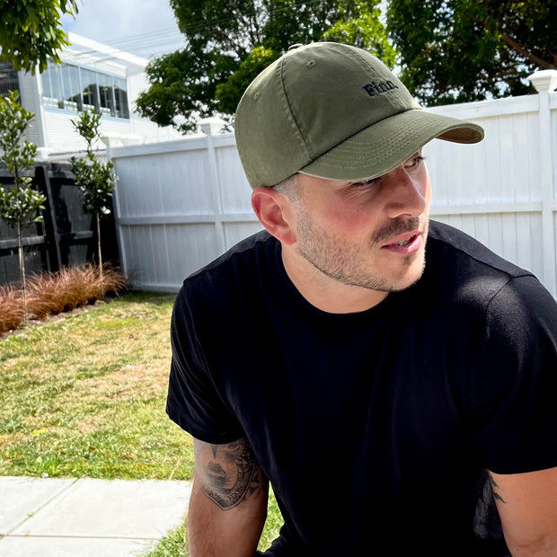 Model relaxing in the Olive Green Acts of Leisure Cap