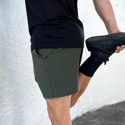 Side View of model wearing Squad Green Body Move Shorts