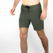 Front view of model wearing Squad Green shorts 